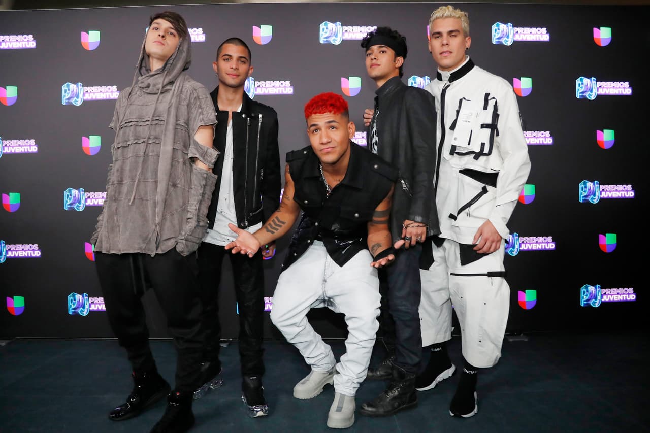 Latin American boy band CNCO pose for a photo as they walk the red carpet before the start of the Premios Juventud 2019, Latin awards show, Thursday, July 18, 2019, in Coral Gables, Fla. (AP Photo/Wilfredo Lee)