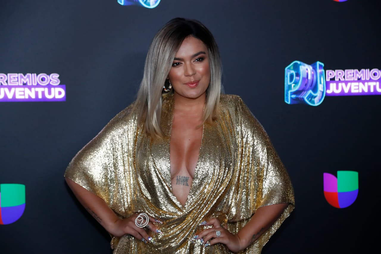 Colombian singer Karol G poses for a photo as she walks the red carpet before the Premios Juventud 2019, Latin awards show, Thursday, July 18, 2019, in Coral Gables, Fla. (AP Photo/Wilfredo Lee)